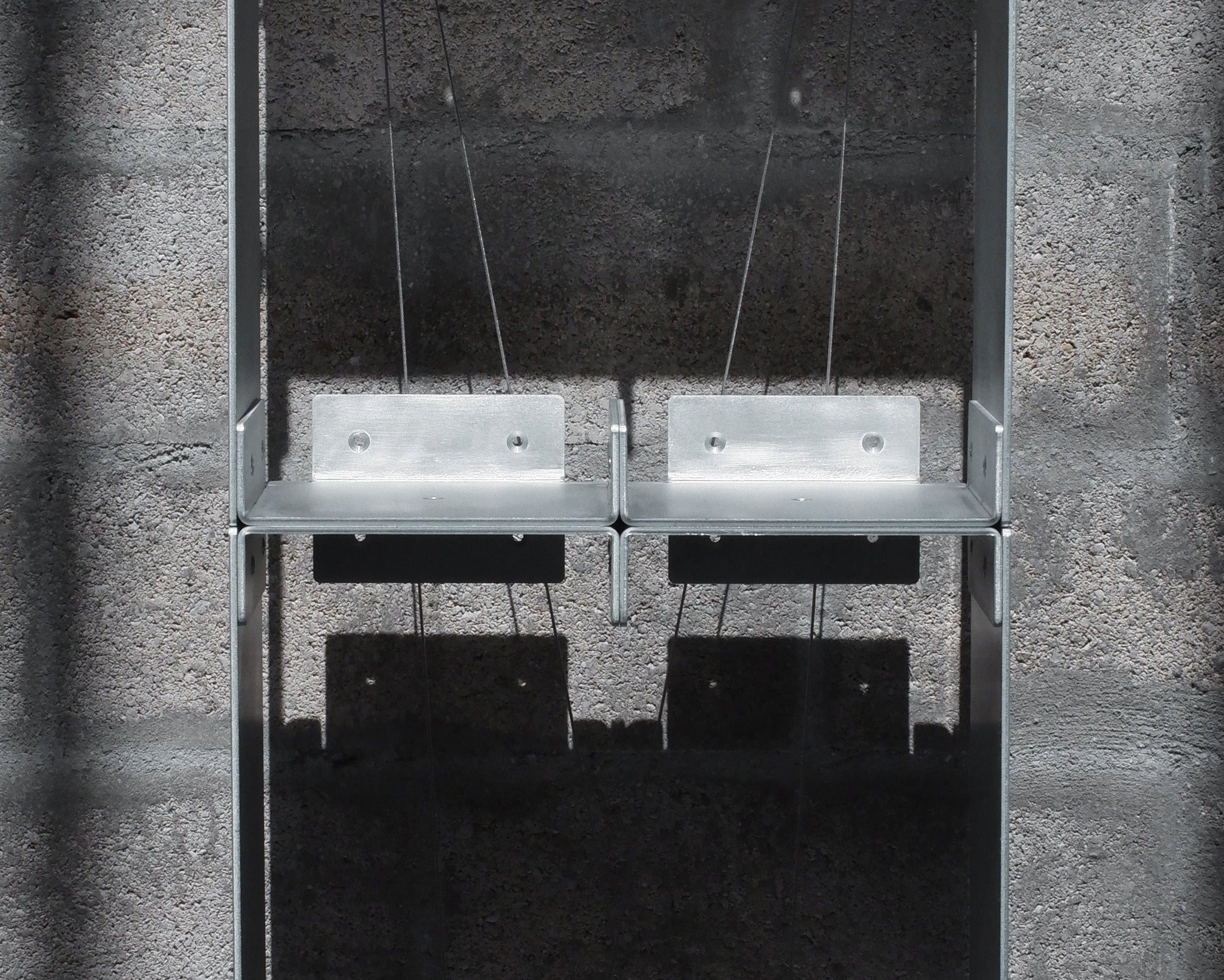 Metal shelving unit against a concrete wall