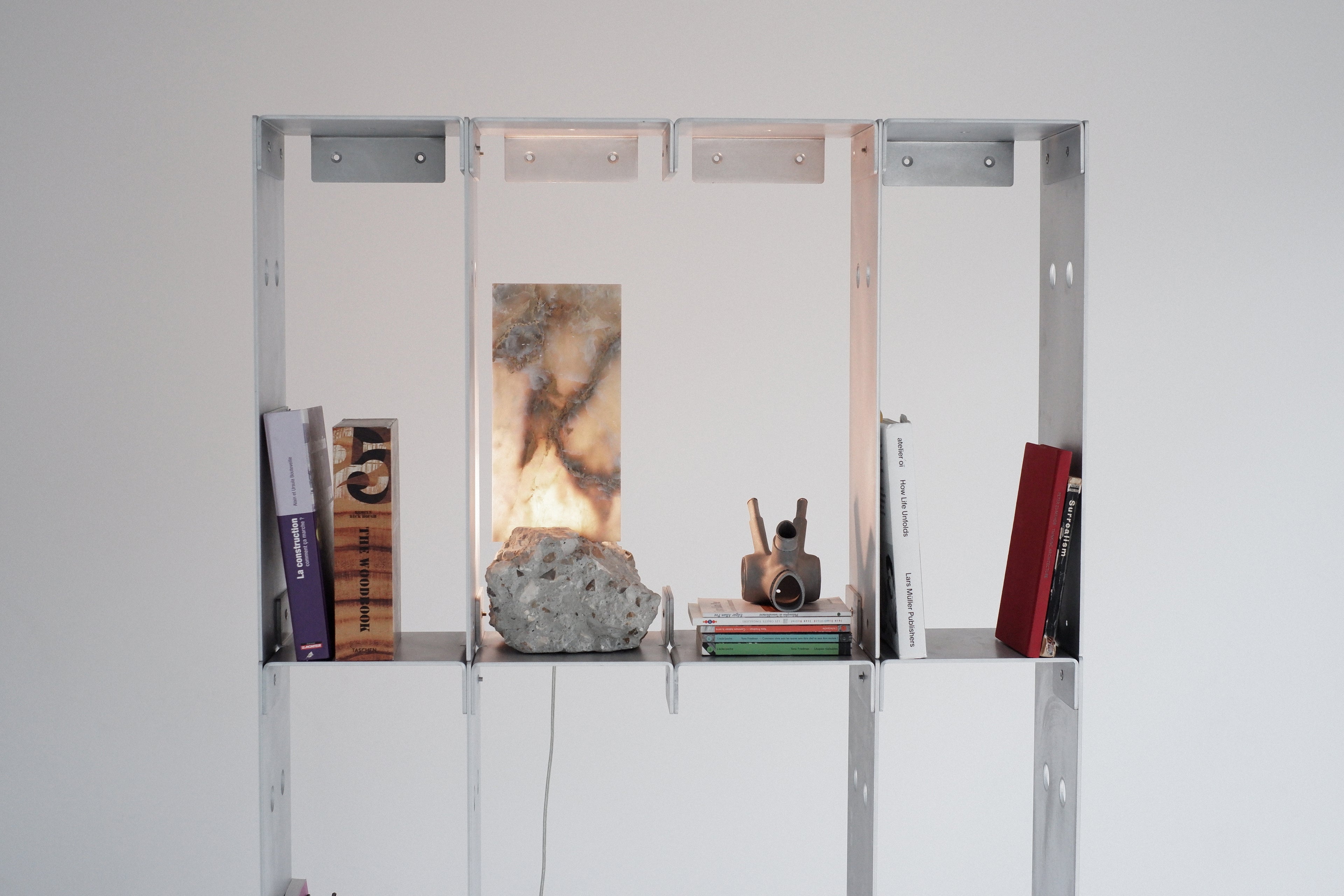 metal shelving unit with decorative items against a white wall