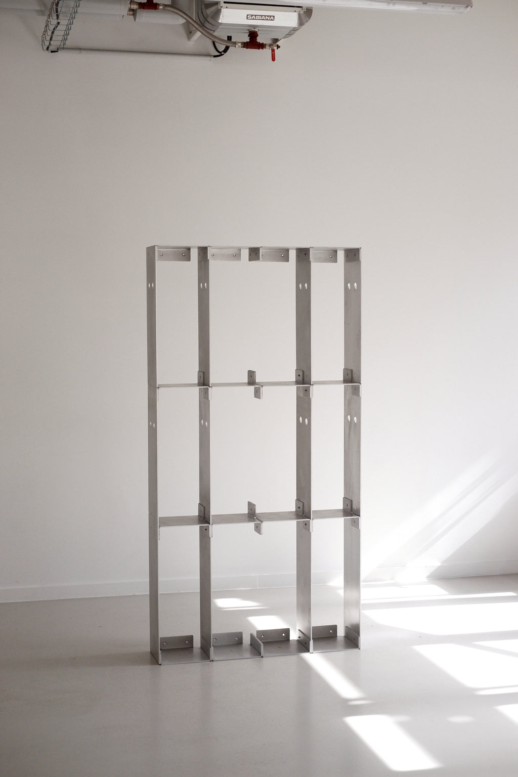 Metal shelving unit against a white wall