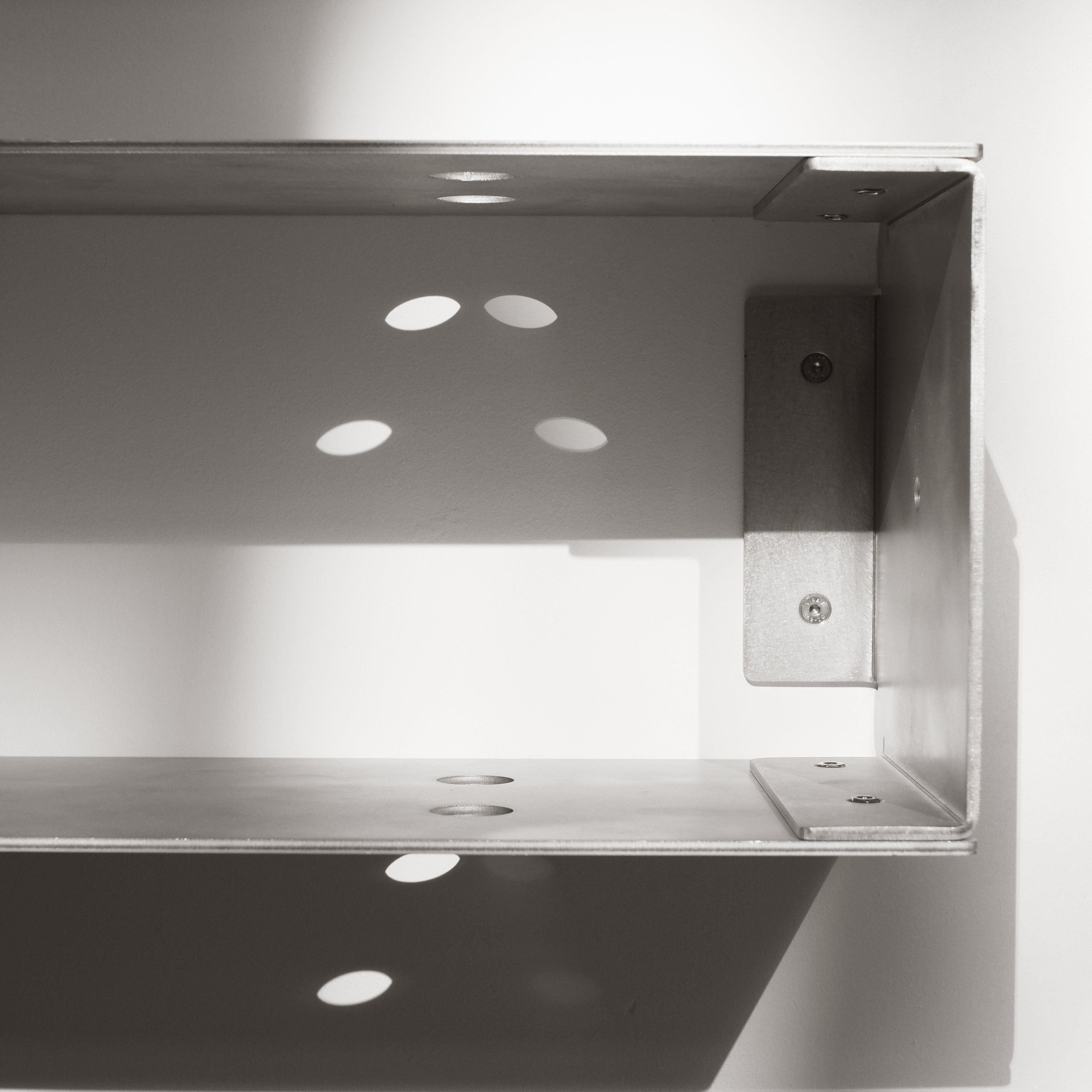 Metallic shelf bracket on a white background