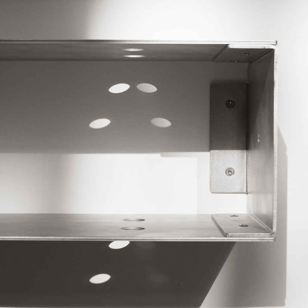 Metallic shelf bracket on a white background