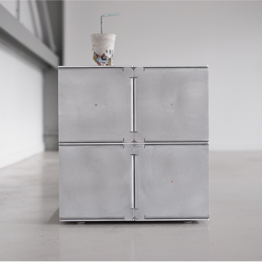 Modern metallic table with a minimalist design in a neutral setting