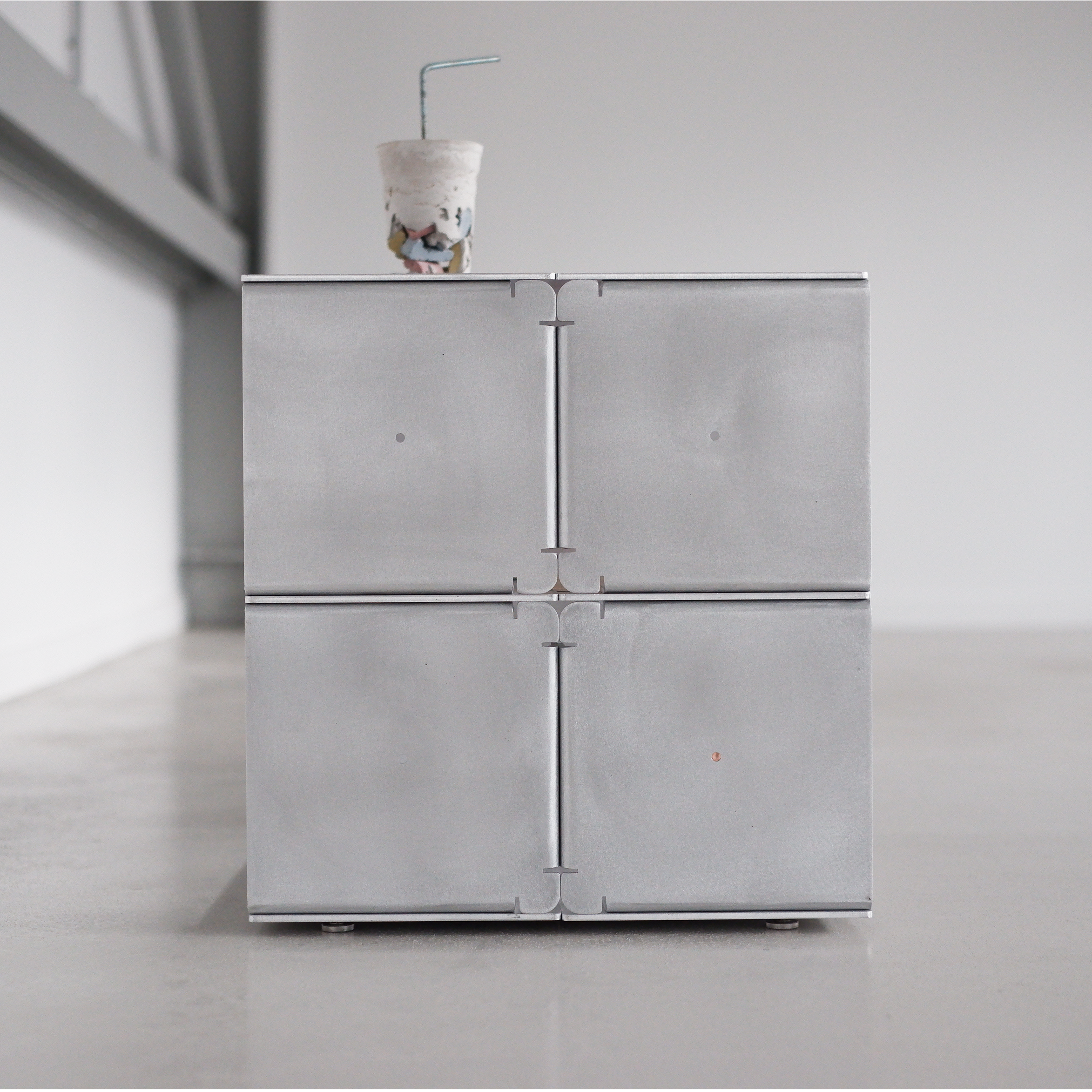 Modern metallic table with a minimalist design in a neutral setting