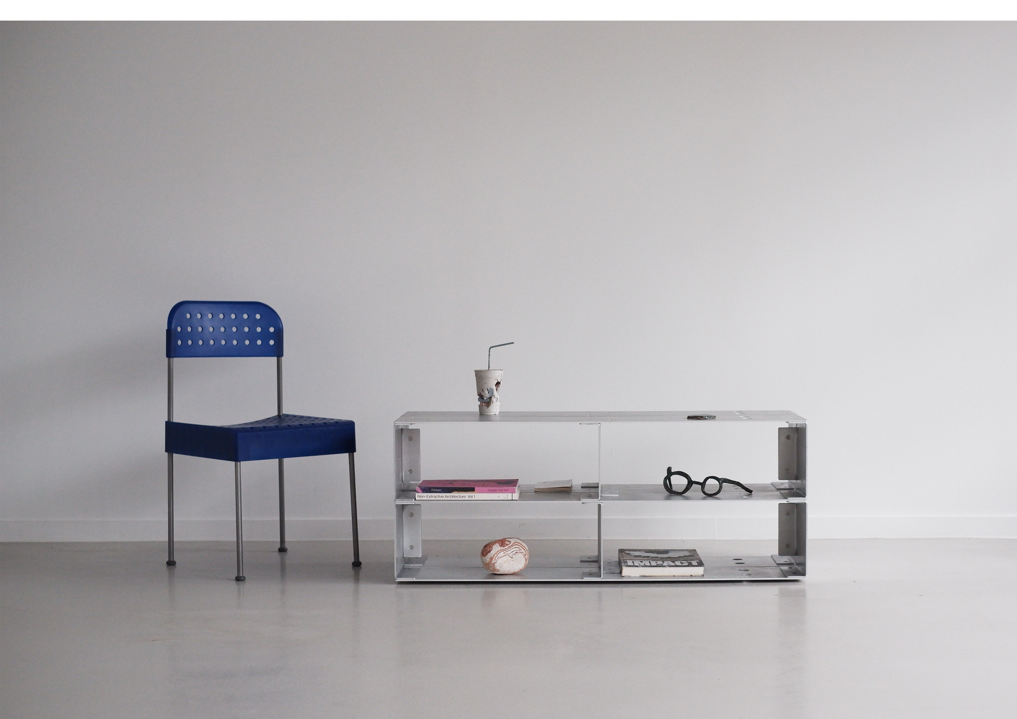 chair and metal coffee table with decorative items on a plain background