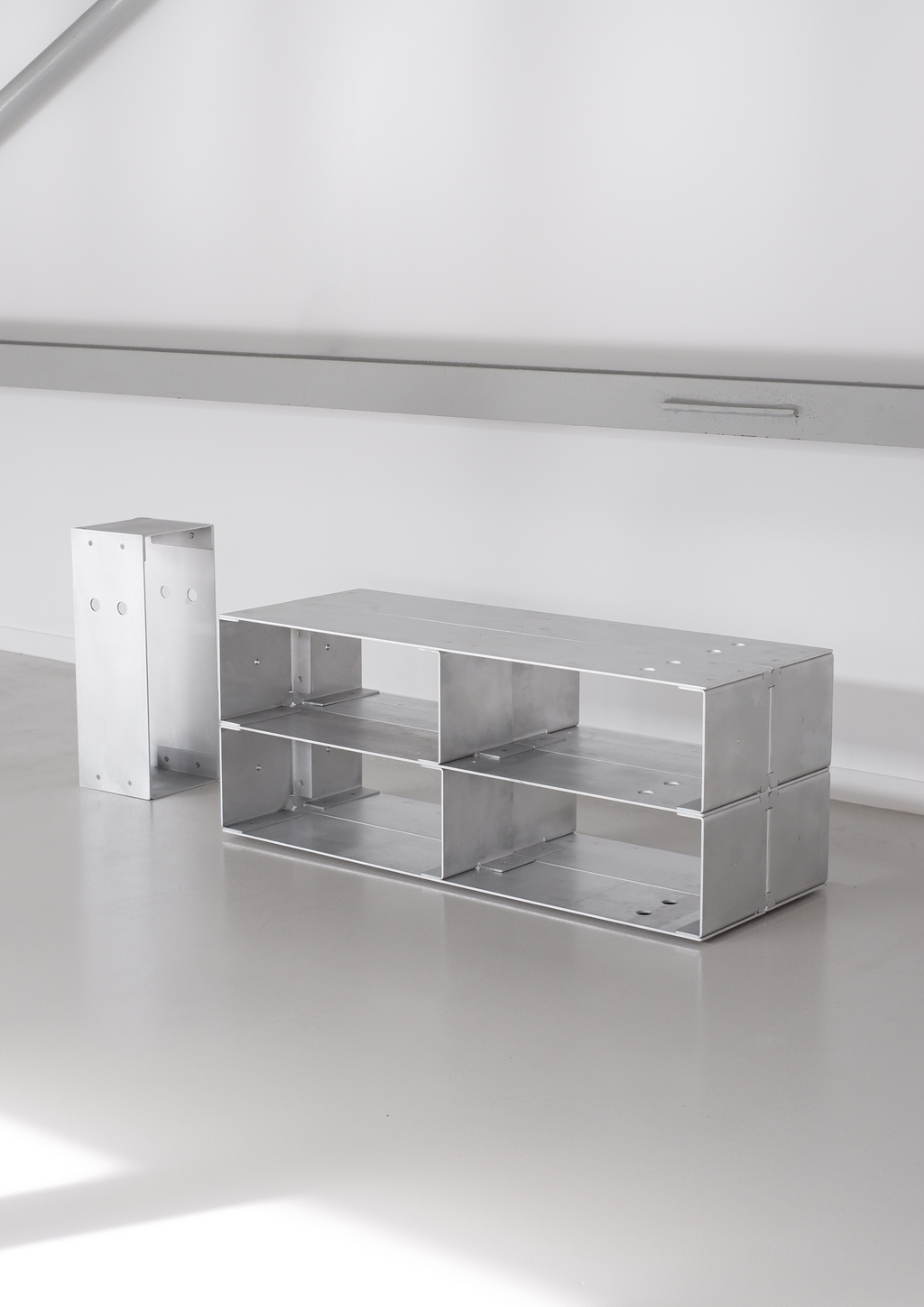 Metallic table on reflective surface with a white background