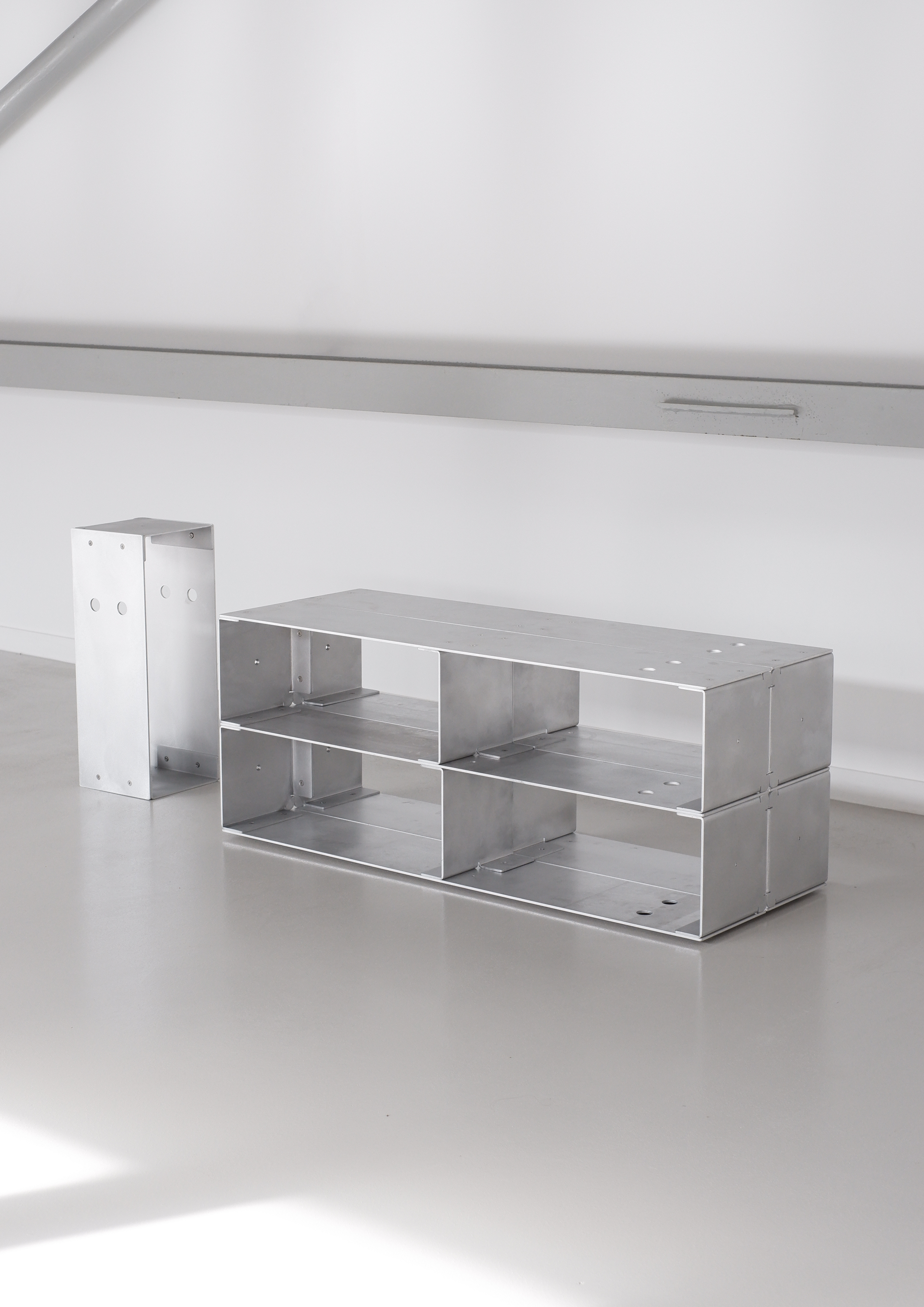 Metallic table on reflective surface with a white background