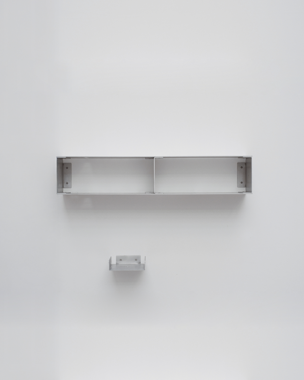 Metal shelf mounted on a white wall