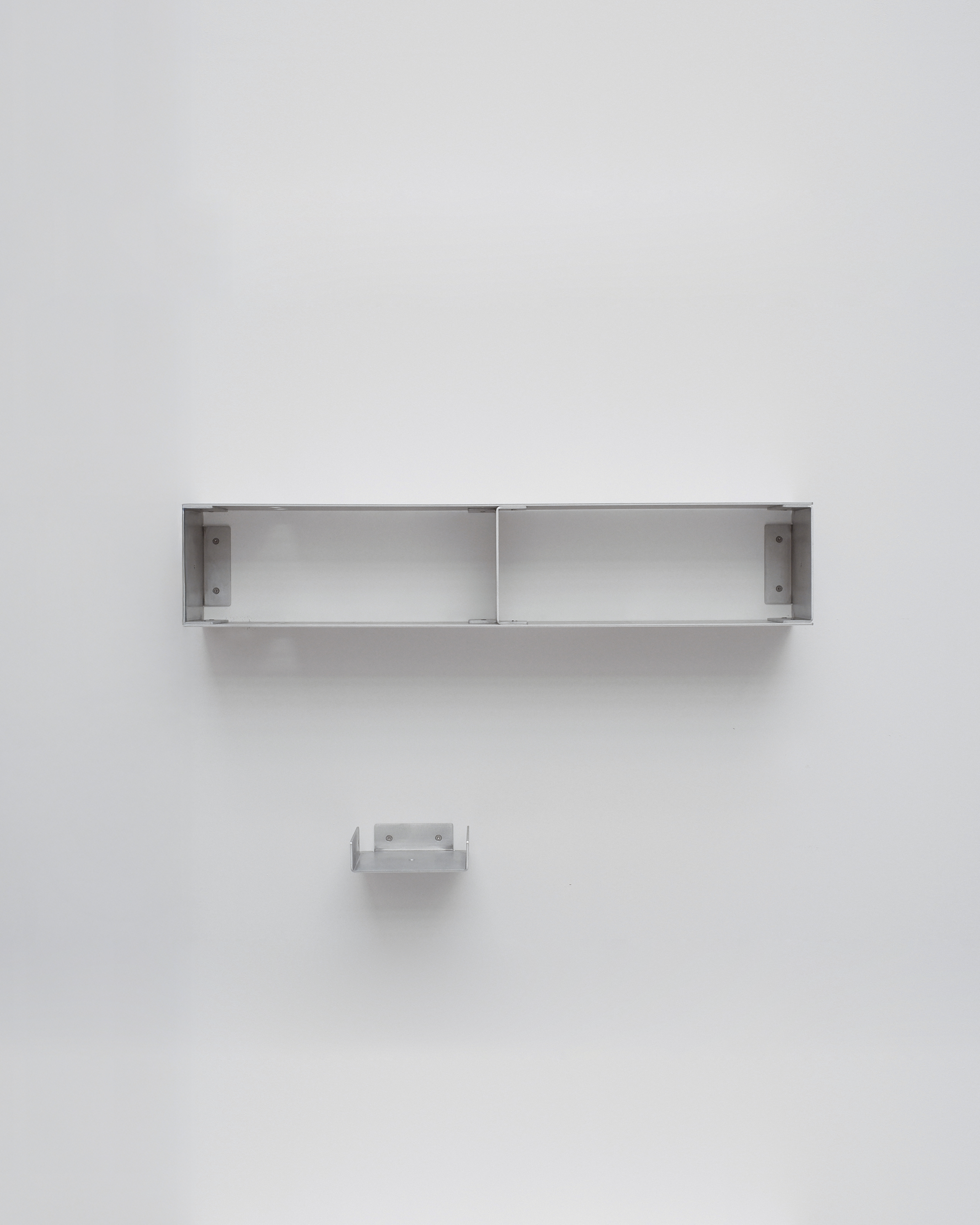 Metal shelf mounted on a white wall