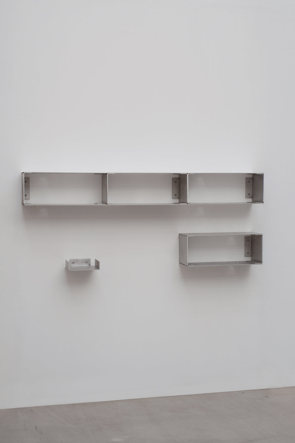 Set of metal shelves on a white wall