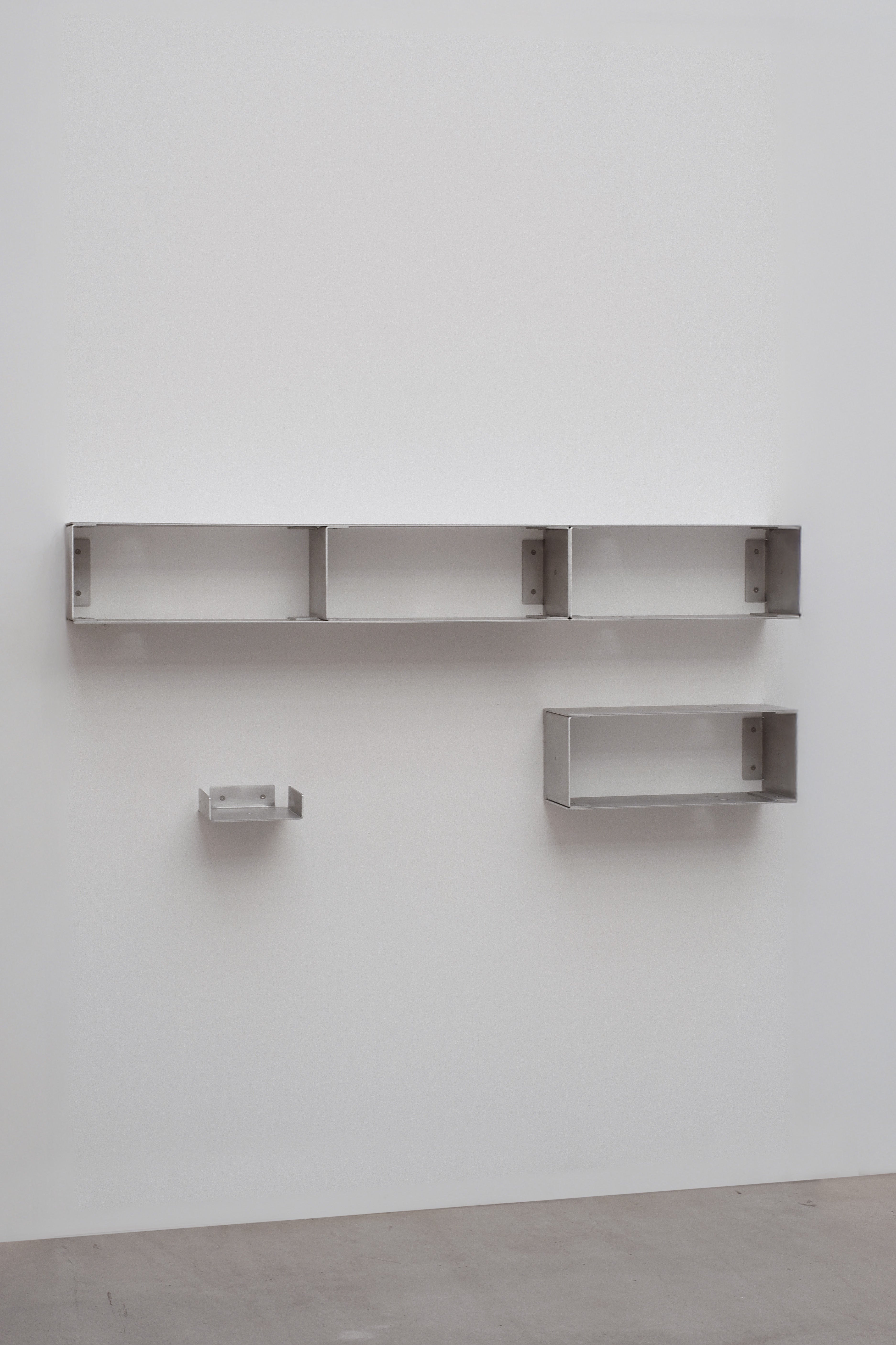 Set of metal shelves on a white wall