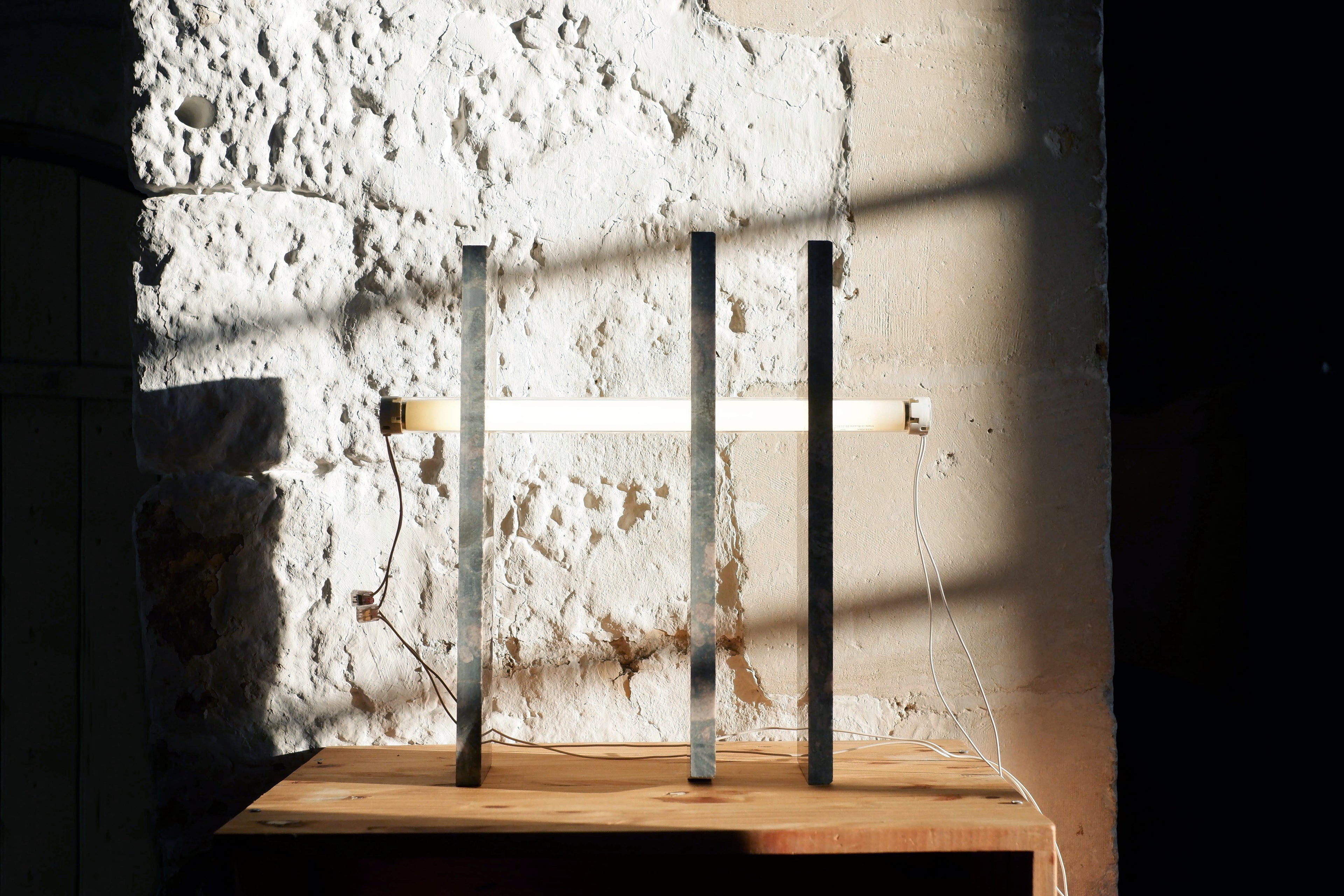 Modern lamp on a wooden table with textured wall background